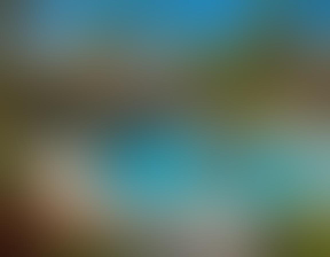 A sunny, serene nudist resort scene showcasing diverse families enjoying clothing-optional activities like sunbathing and playing games by a sparkling pool, surrounded by lush greenery and colorful flowers. Children are joyfully splashing in the water while adults engage in friendly conversations under swaying palm trees, evoking a sense of freedom and community. The atmosphere is warm and inviting, emphasizing the bliss of natural living. super-realistic. vibrant colors. clear blue sky.